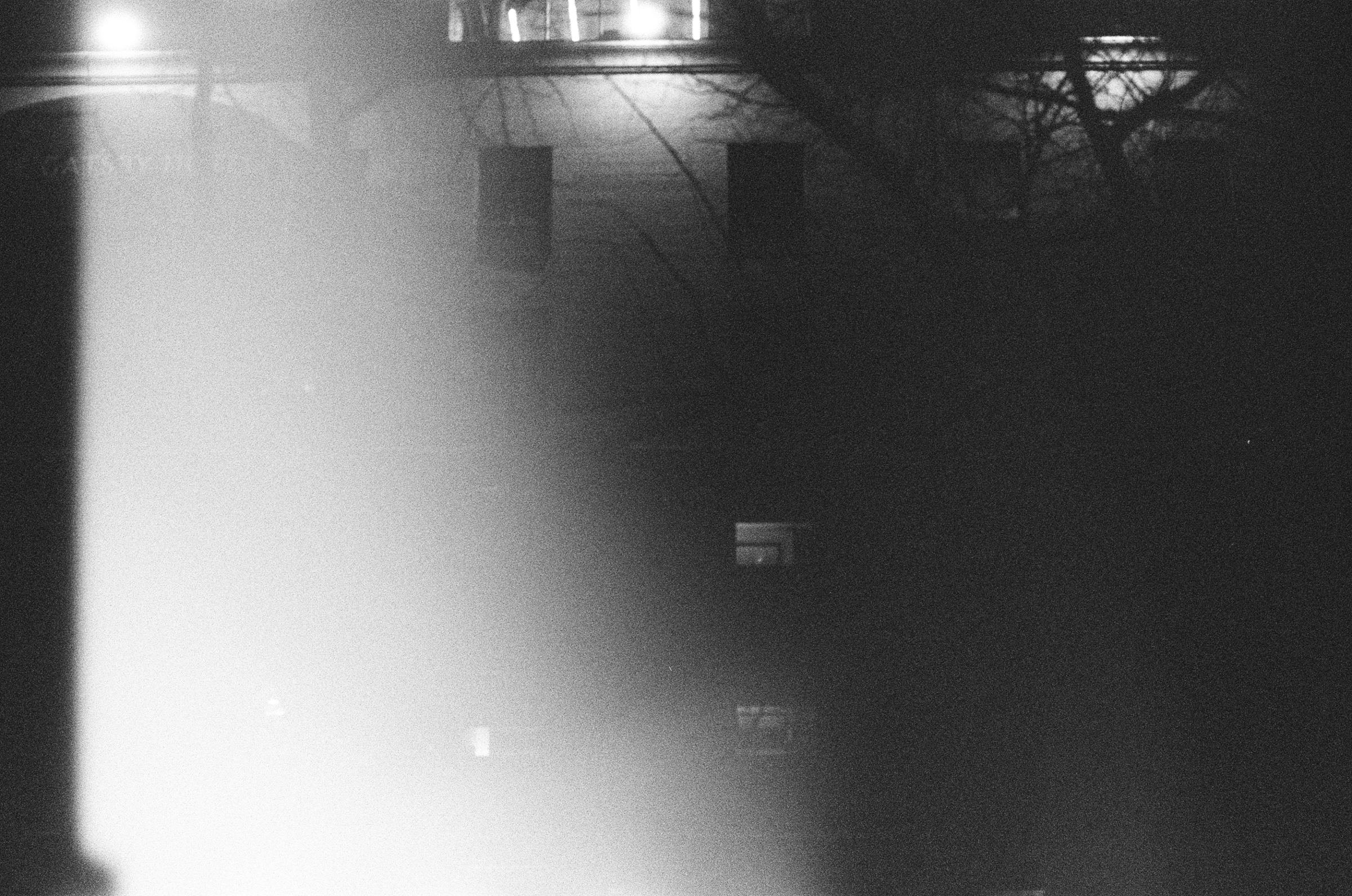 A building at night half dissolved in a wash of light